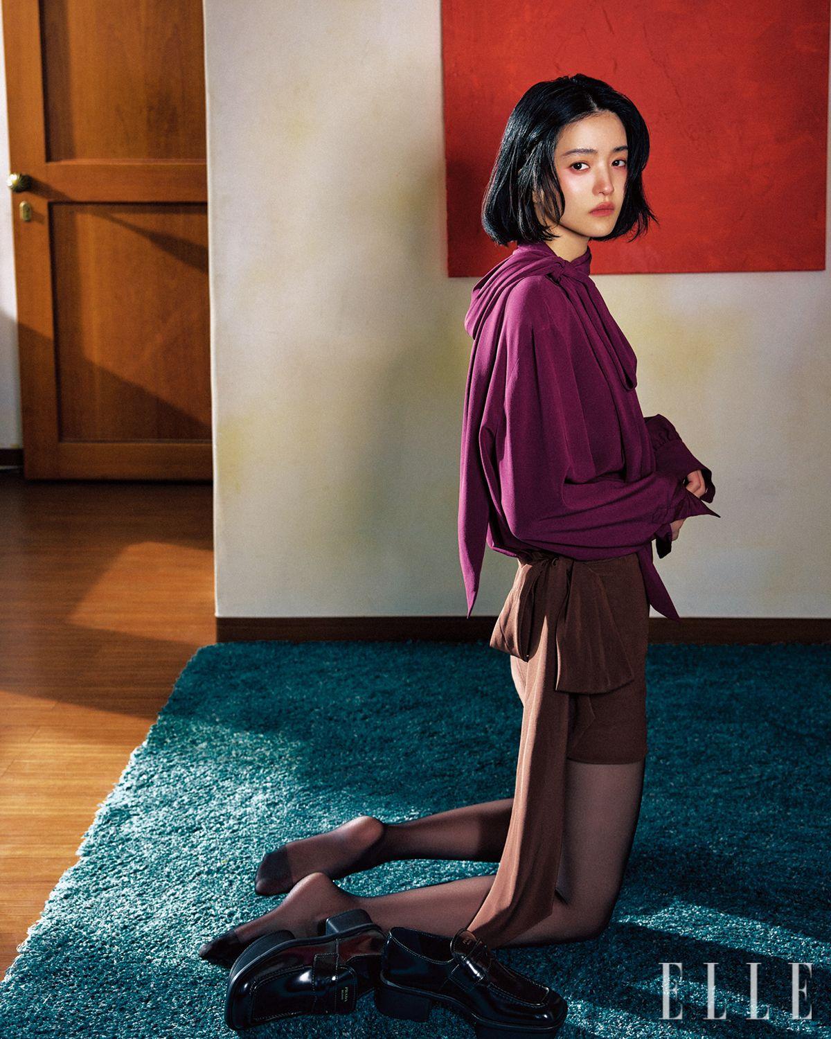 리본 디테일의 실크 블라우스와 스커트, 청키한 이퀄 로퍼는 모두 Prada. 