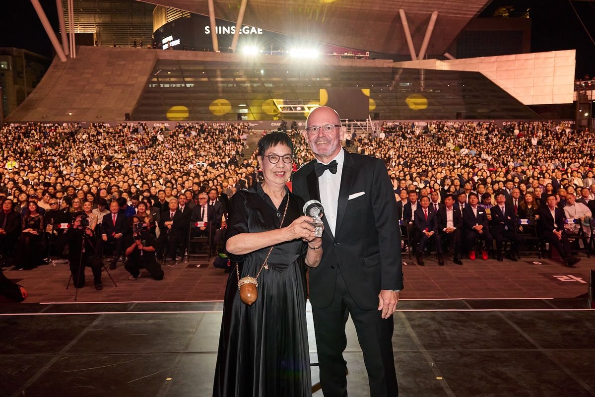 제 31회 부산국제영화제 개막식에서 '2026 까멜리아상'을 수상한 허안화 감독과 시상자 샤넬코리아 대표 클라우스 올데거.