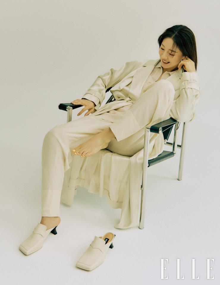 실키한 코트와 니트 톱, 팬츠는 모두 Tod's. 크림 컬러 블로퍼는 Rekken. 조형적인 디자인의 이어링은 COS.