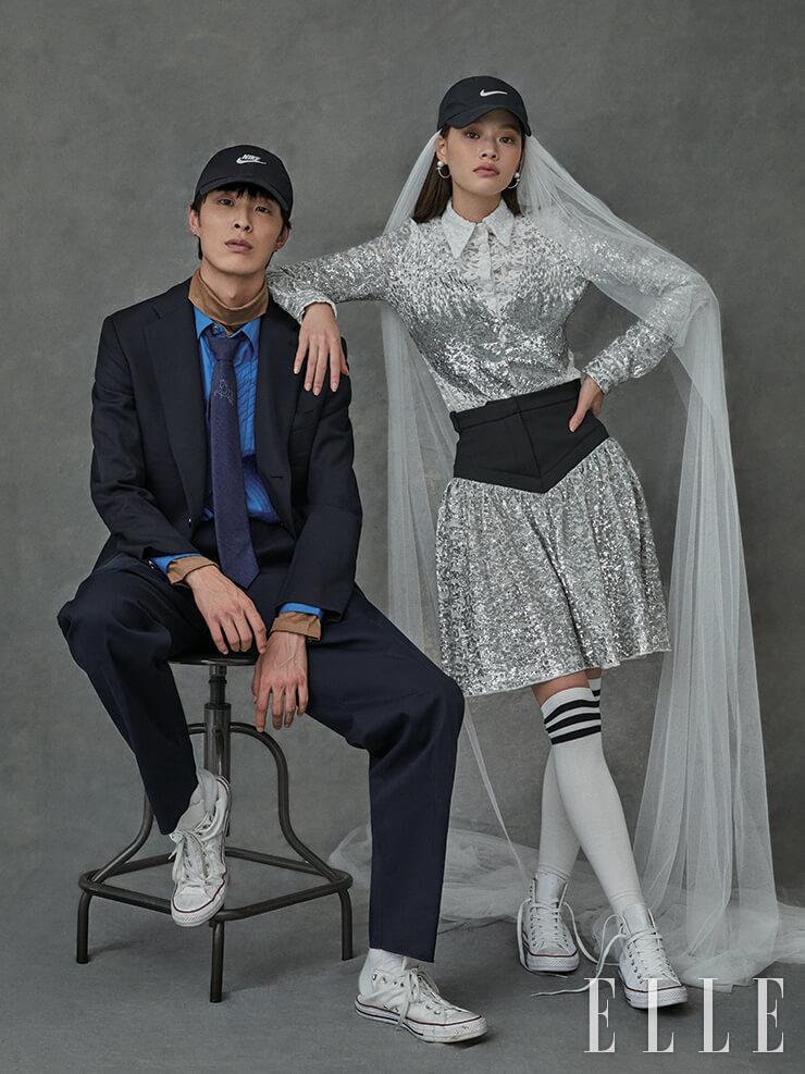 박진이 입은 터틀넥과 셔츠, 재킷, 팬츠, 타이는 가격 미정, 모두 Hermès. 햇은 가격 미정, Nike. 스니커즈는 9만2천원, Converse. 삭스는 스타일리스트 소장품. 김아현이 입은 스팽글 블라우스와 스커트는 가격 미정, 모두 Louis Vuitton. 햇은 가격 미정, Nike. 진주 후프 이어링은 11만원, Calvin Klein watches & Jewelry. 스니커즈는 가격 미정, Converse. 베일은 가격 미정, The Queen Lounge. 삭스는 스타일리스트 소장품.