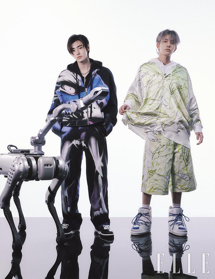 성훈이 입은 그래픽 패턴의 재킷과 팬츠는 모두 Gerrit Jacob. 후디드 집업은 Chrome Hearts. 블랙 스니커즈는 Off-White™. 네크리스는 Yv˙˙min. 희승이 입은 그래픽 패턴 셔츠와 쇼츠는 모두 Gerrit Jacob. 후디드 톱은 스타일리스트 소장품. 나일론 부츠는 Moon Boot. 네크리스는 Yv˙˙min. 이어링은 Scudo. 이어 커프는 Hustad. 선글라스는 Maison MargielaxGentle Monster.