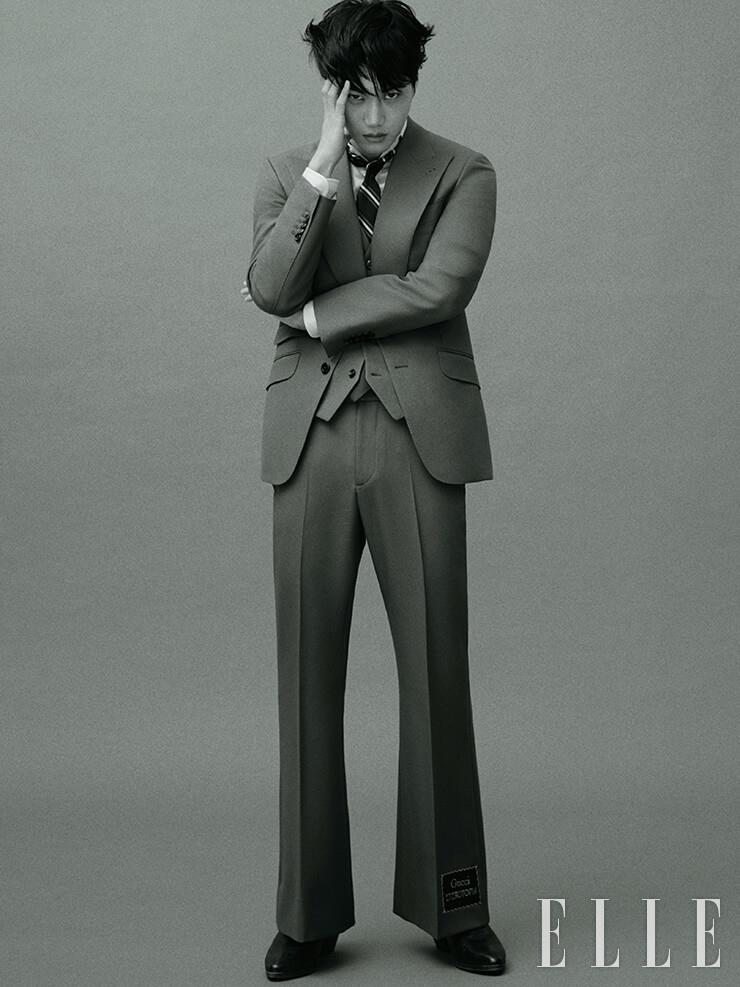  스리피스 수트와 코튼 셔츠, 스트라이프 패턴의 타이, 앵클부츠는 모두 Gucci.