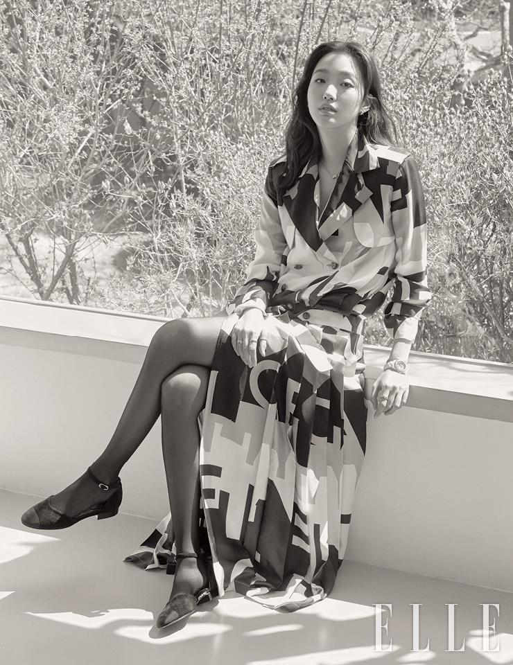 기계식 셀프 와인딩 매뉴팩처 칼리버 12.1을 탑재한 화이트 세라믹 브레이슬렛 J12 워치. 함께 레이어드한 코코 크러쉬 오픈 뱅글, 오른손 첫 번째와 두 번째 손가락의 18K 코코 크러쉬 미니 사이즈 링, 네 번째 손가락의 퀼팅 모티프 코코 크러쉬 스몰 링, 베이지골드 소재의 다이아몬드 코코 크러쉬 네크리스, 퀼팅 장식의 옐로골드 코코 크러쉬 이어링은 모두 Chanel Watches & Fine Jewelry.