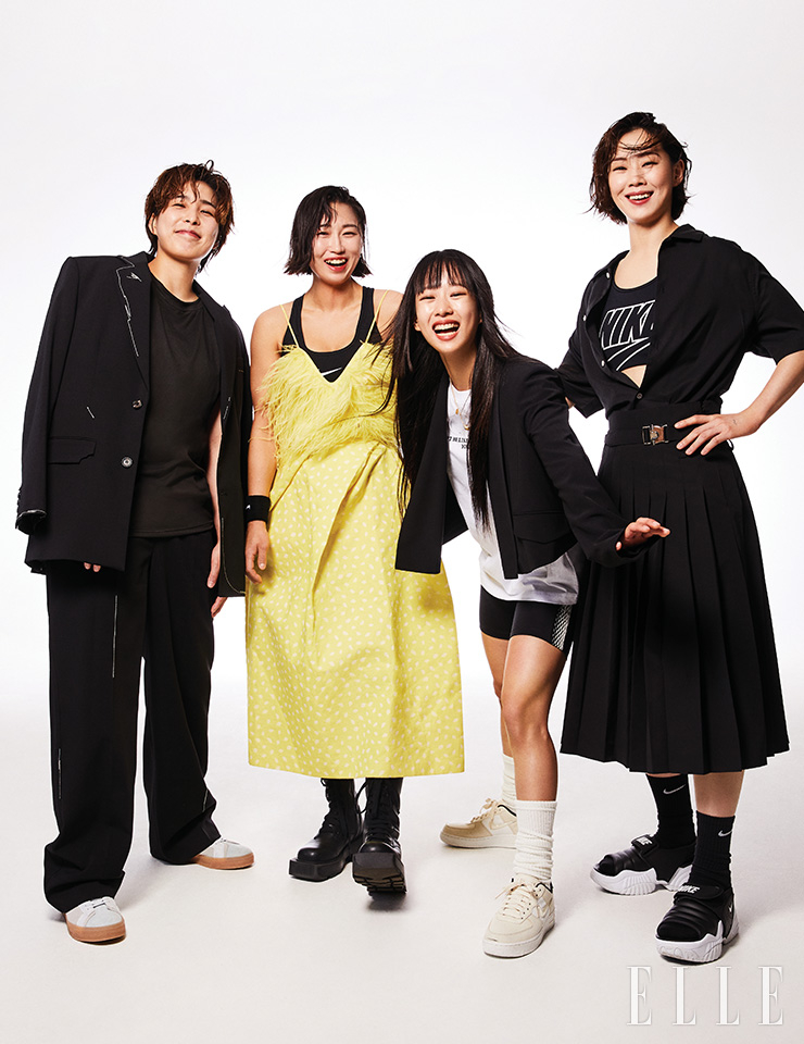 성연이 입은 블랙 세트업은 Ader Error x Zara. 스니커즈는 Nike. 안에 입은 슬리브리스 톱은 스타일리스트 소장품. 희정이 입은 브라톱과 손목에 착용한 아대는 모두 Nike. 옐로 투피스는 Sonjungwan. 레이스업 워커는 Charles & Keith. 슬리브리스는 스타일리스트 소장품. 민선이 입은 티셔츠는 Moont. 바이커 쇼츠는 Lacoste. 크롭트 재킷은 D’de Moo. 스니커즈는 Nike. 네크리스는 Ajinco. 니트 삭스는 스타일리스트 소장품. 은별이 입은 브라톱은 Nike. 실크 블라우스는 COS. 플리츠스커트는 Comgen. 삭스와 샌들은 모두 Nike. 