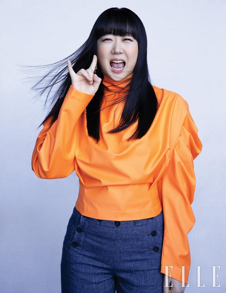 김하정이 입은 터틀 블라우스는 Dint. 더블 버튼 팬츠는 Weekend Maxmara. 드롭 이어링은 Vaseul.