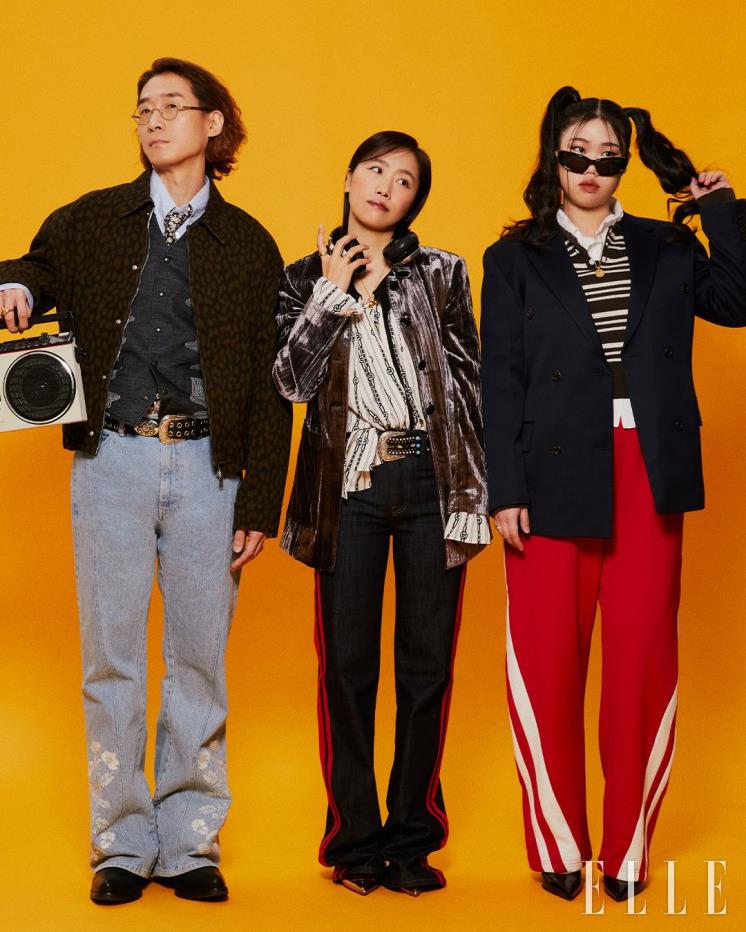 (왼쪽부터) 추승엽이 입은 재킷은 Maison Kitsuné, 이너 블루 셔츠는 Studio Nicholson, 팬츠는 From Arles, 부츠 Jimmy Choo, 안경은 본인 소장품, 베스트와 타이와 링은 모두 스타일리스트 소장품. 강성희가 입은 그레이 재킷은 GANNI by BEAKER, 이너 패턴 블라우스는 Johnny Hates Jazz, 팬츠는 RED Valentino by YOOX, 골드 힐은 Gianvito Rossi, 네크리스는 Portrait Report, 벨트와 링은 모두 스타일리스트 소장품. 신해솔이 입은 재킷은 EENK, 스트라이프 니트는 VOCAVACA, 이너 화이트 셔츠는 Beaker, 팬츠는 SEOUU, 힐은 Dolce&Gabbana, 선글라스는 Gentle Monster, 네크리스는 Portrait Report, 링은 스타일리스트 소장품.