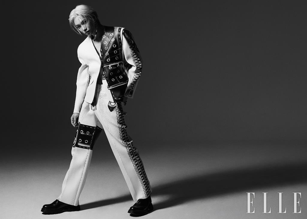 벨트와 지퍼 프린트의 레더 재킷과 팬츠, 앵클부츠, 드롭 이어링은 모두 Louis Vuitton.