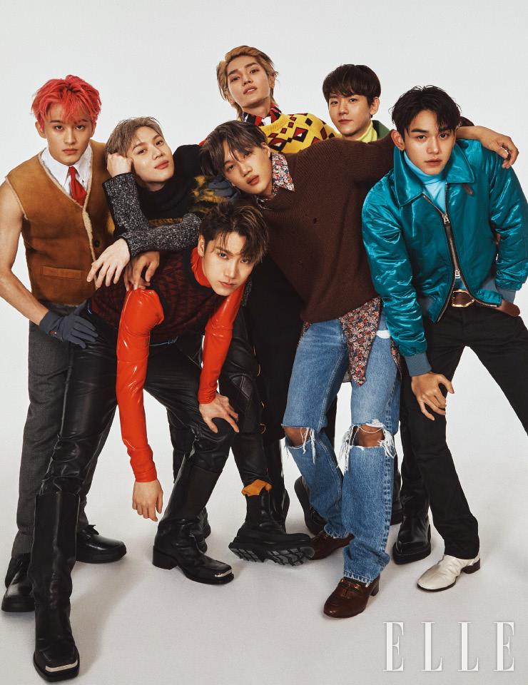 마크가 입은 스웨이드 베스트와 셔츠, 팬츠, 타이, 슈즈, 글러브는 모두 Prada. 텐이 입은 베스트와 라텍스 소재의 톱, 팬츠, 롱부츠는 모두 Givenchy. 태민이 입은 터틀넥과 바이커 팬츠, 첼시 부츠는 모두 Alexander McQueen. 태용이 입은 그래픽 패턴의 니트 톱과 셔츠, 타이, 팬츠, 롱부츠는 모두 Prada. 카이가 입은 니트 톱과 플로럴 패턴의 셔츠, 데님 팬츠, 로퍼는 모두 Gucci. 백현이 입은 레더 재킷과 터틀넥, 니트 톱, 부츠는 모두 Berluti. 레더 팬츠는 스타일리스트 소장품. 루카스가 입은 블루종과 터틀넥, 벨트, 부츠는 모두 Tom Ford. 팬츠는 스타일리스트 소장품.